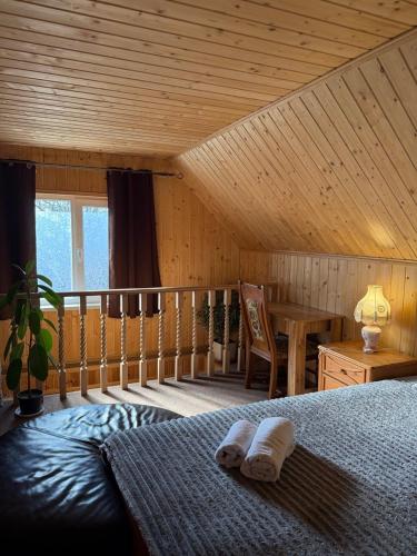 a bedroom with a bed and a wooden ceiling at KOMFORT in Berehove