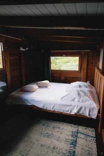 a bed in a room with a window at Banana Cottage Ecolodge & Spa in Le Gosier