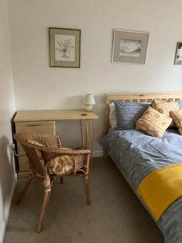 a bedroom with a bed and a desk and a chair at 18 Wixon Path in Buckinghamshire