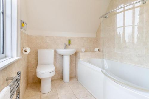 a bathroom with a toilet and a sink and a bath tub at 2 Bed in Wem oc-o30240 in Preesgreen