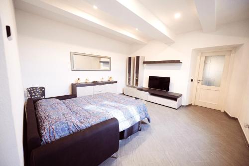 a bedroom with a bed and a television in it at Residenza Caterina in Maslianico