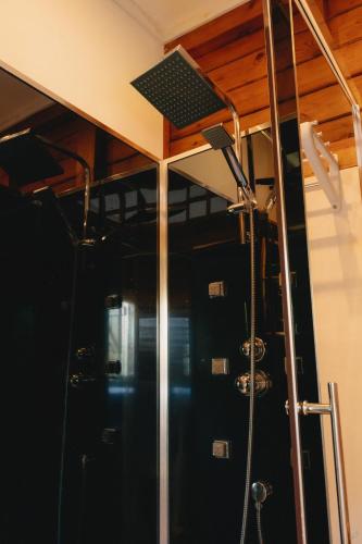 a shower in a room with a ceiling at Banana Cottage Ecolodge & Spa in Le Gosier