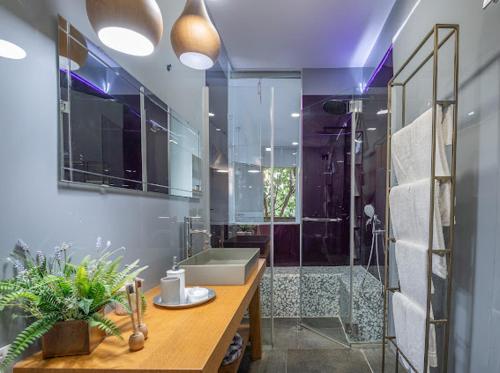a bathroom with a sink and a shower with a tub at Felina place by shuli in Ganne Yoẖanan