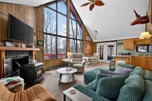 a living room with a blue couch and a fireplace at Pet-Friendly w Fire Pit Grill & Resort Access in Hedgesville