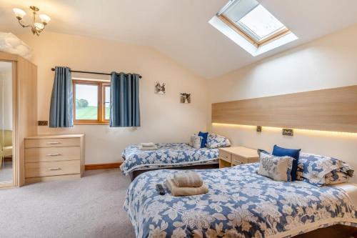 a bedroom with two beds and a skylight at 4 Bed in Wonastow oc-k29425 in Wonastow