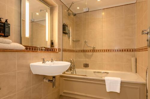 a bathroom with a sink and a bath tub at Winchester Cathedral View By Dancenter in Winchester