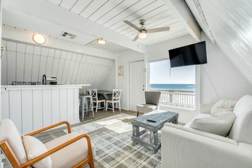 a living room with a view of the ocean at Iconic A Frame Sleep Over the Gulf in Surfside Beach