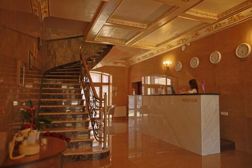 a lobby with a spiral staircase in a building at Passage Hotel Restaurant in Goris