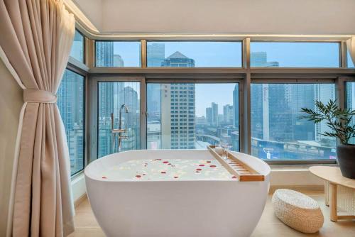 a bath tub in a room with a large window at 妮可酒店解放碑店 in Chongqing