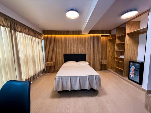 a bedroom with a bed and a tv in it at Matrix Alojamiento in Punta Negra