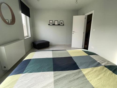 una camera da letto con un letto su cui è appoggiata una coperta colorata di JoHa Haus a Hasselt