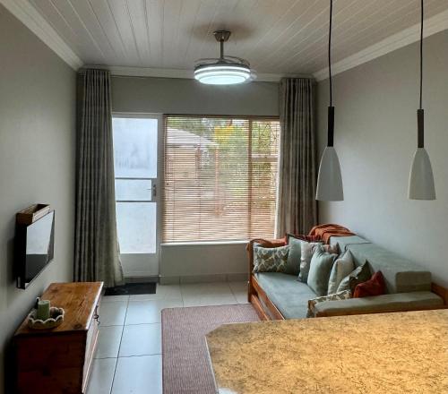 a living room with a couch and a tv at Joba-Rus in Bloemfontein