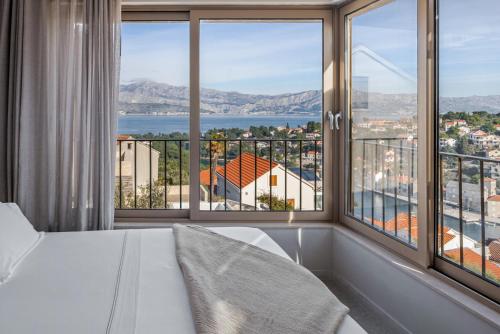 a bedroom with a large window with a view at Lemon Tree Villa in Splitska