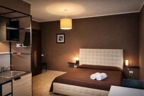 a bedroom with a large bed and a sink and a sink at MyBed B&B in Cavallino di Lecce