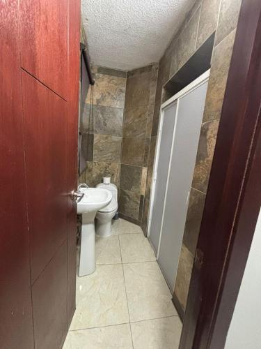 a bathroom with a toilet and a sink at Depa Balbuena in Guadalajara