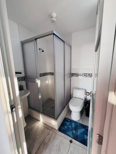 a bathroom with a shower and a toilet at Sun Terrace Ilo Loft in Ilo