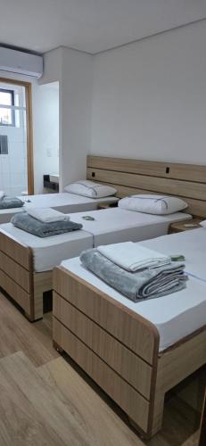 a room with four beds in a room at Platinum Hotel in São Paulo