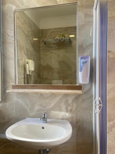 a bathroom with a sink and a mirror at Hotel Center 1 in Rome
