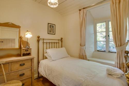 a bedroom with a bed and a dresser and a window at 3 Bed in Little Langdale oc-gl102 in Little Langdale