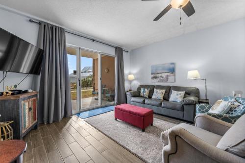 a living room with a couch and a tv at The Dunes 101 by Vacation Homes Collection in Fort Morgan
