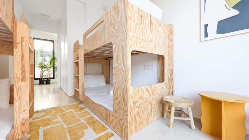 a room with a bunk bed with a table and a stool at Villa Horizonte in Finestrat