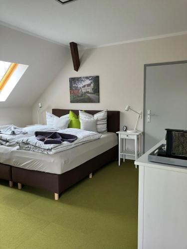 a bedroom with a large bed with white pillows at Biohotel Schönhagener Mühle in Pritzwalk