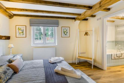a bedroom with a large bed and a bathroom at 3 Bed in Callaughton oc-b34809 in Much Wenlock