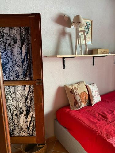 a bedroom with a bunk bed with a red bed sidx sidx sidx at Beautiful chalet accommodation with covered parking in Cianfuran