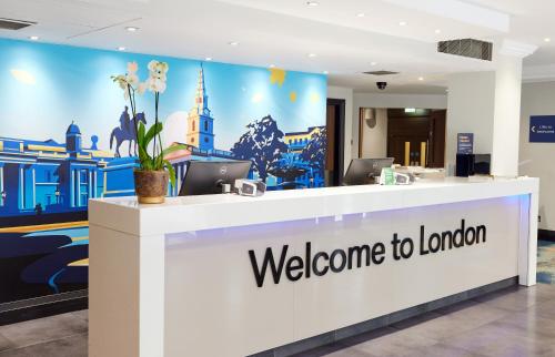 a welcome to london reception desk in a lobby at Thistle Trafalgar - Leicester Square in London