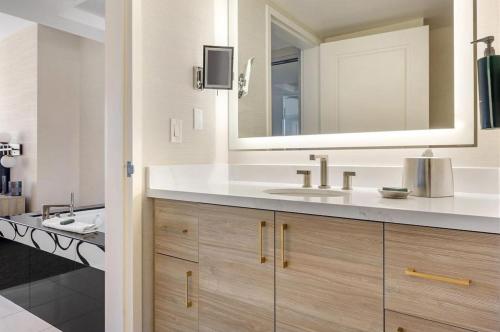a bathroom with a sink and a mirror at Suites at Elara Las Vegas Center Strip-No Resort Fees in Las Vegas
