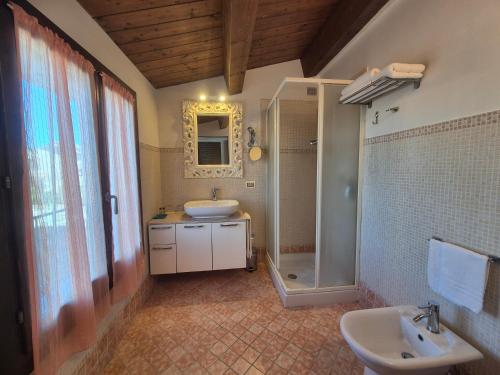 a bathroom with a sink and a shower and a toilet at B&B Bella di Notte in Lugo