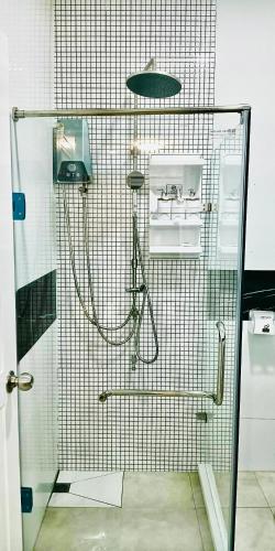 a shower with a glass door in a bathroom at Leelavadee Villa Sea Views in Tha Sala