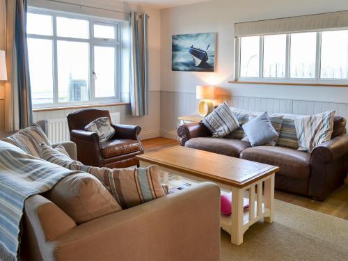 a living room with two couches and a coffee table at Gullsway in Beadnell