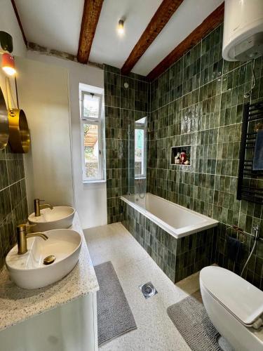 a bathroom with two sinks and a bath tub at Exceptional Home-5 min from Porto Montenegro Tivat in Tivat