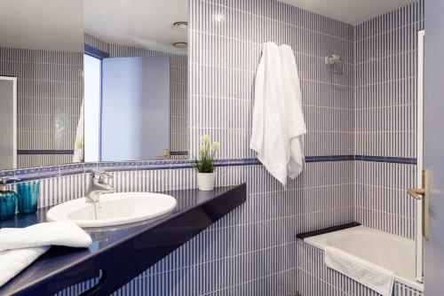 a bathroom with a sink and a mirror at El Trull Apartments in Lloret de Mar