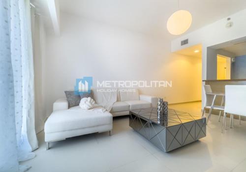 a living room with a white couch and a table at Gate Tower, 1BR Reem Island, Near Galleria, Abu Dhabi Mall & the City in Abu Dhabi