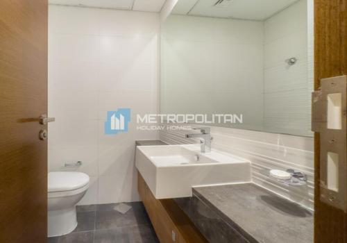 a bathroom with a sink and a toilet and a mirror at Gate Tower, 1BR Reem Island, Near Galleria, Abu Dhabi Mall & the City in Abu Dhabi