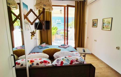 a bedroom with a bed with a view of the ocean at Kadena Apartments in Kotor