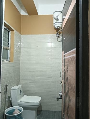 a small bathroom with a toilet and a light at Swagat Lodge in Chāngsāri
