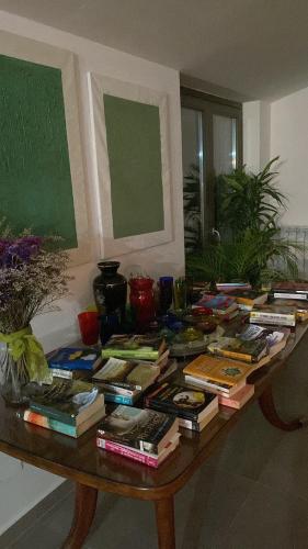 a table filled with books on top of it at Thesan B&B in San Prisco