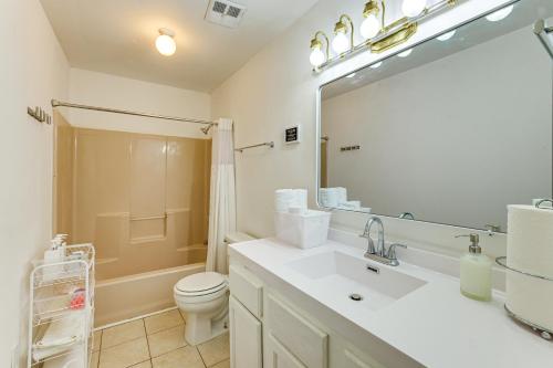 a bathroom with a sink and a toilet and a mirror at Work, Explore & Unwind: Greenville Getaway w/ Yard in Greenville