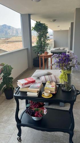 a black coffee table with books and plates on it at Thesan B&B in San Prisco