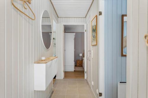 a hallway with a sink and a mirror at TV1705-Bindslev-Nordkapvej-4 in Tversted