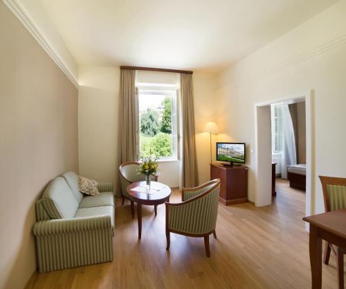 a living room with a couch and a table at Grand Hotel Rogaška Premium in Rogaška Slatina