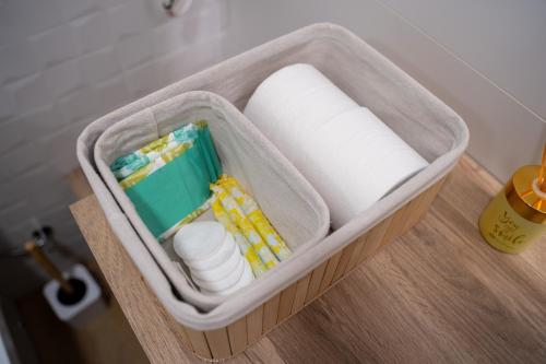 a container filled with toilet paper and other toiletries at Judería Suite Jaén in Jaén