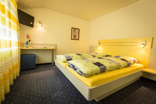 a bedroom with a bed and a desk at Hotel Franz Anton in Sargans