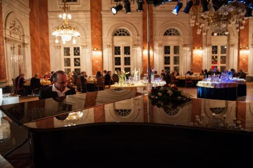 a man sitting at a table in a restaurant at Grand Hotel Rogaška Premium in Rogaška Slatina
