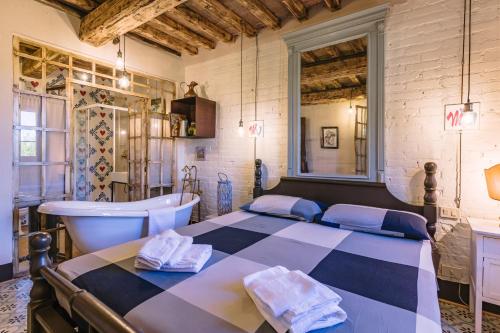 a bedroom with a bed and a tub and a sink at Country House Art and Garden in Monte Antico