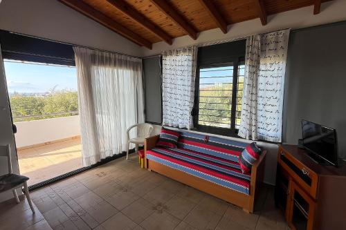 a living room with a couch and a balcony at Villa Maty in Karianí