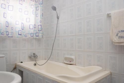 坎帕拉的住宿－Cosmil Executive Suites Najjanankumbi Kampala，白色的浴室设有淋浴和水槽